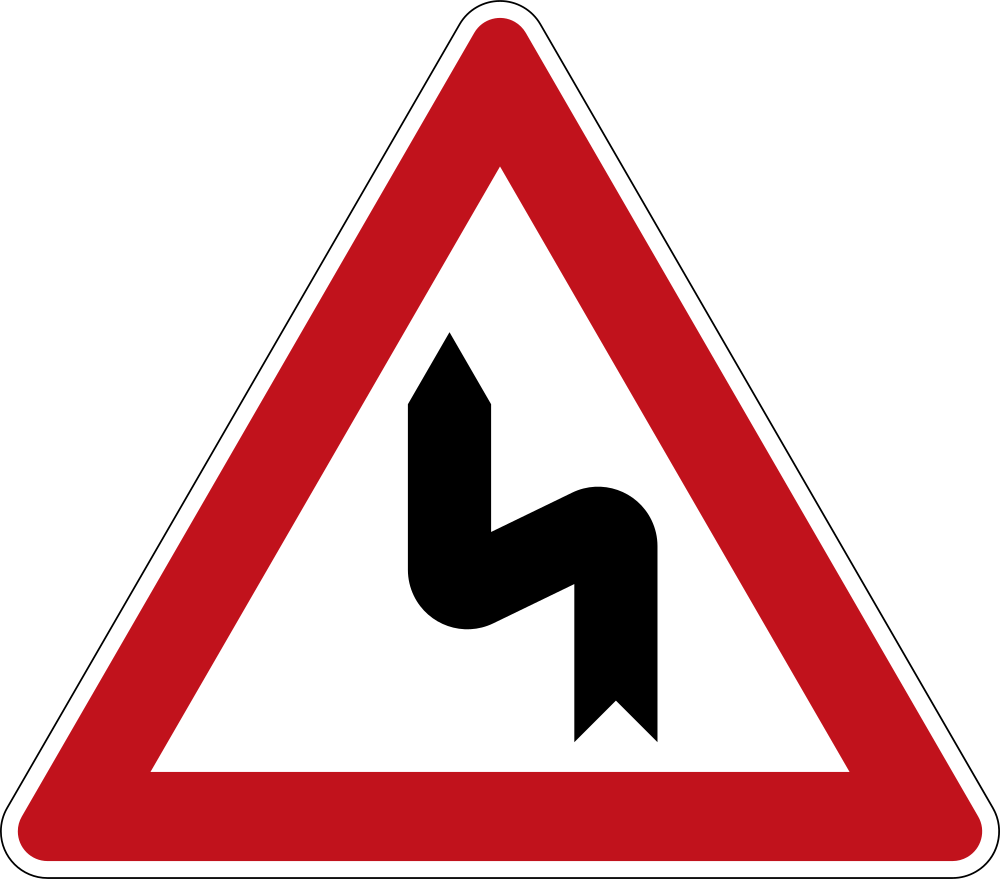 Advertencia de doble curva, primero a la izquierda y luego a la derecha.