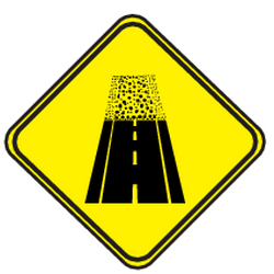Warnung vor unbefestigter Fahrbahn.