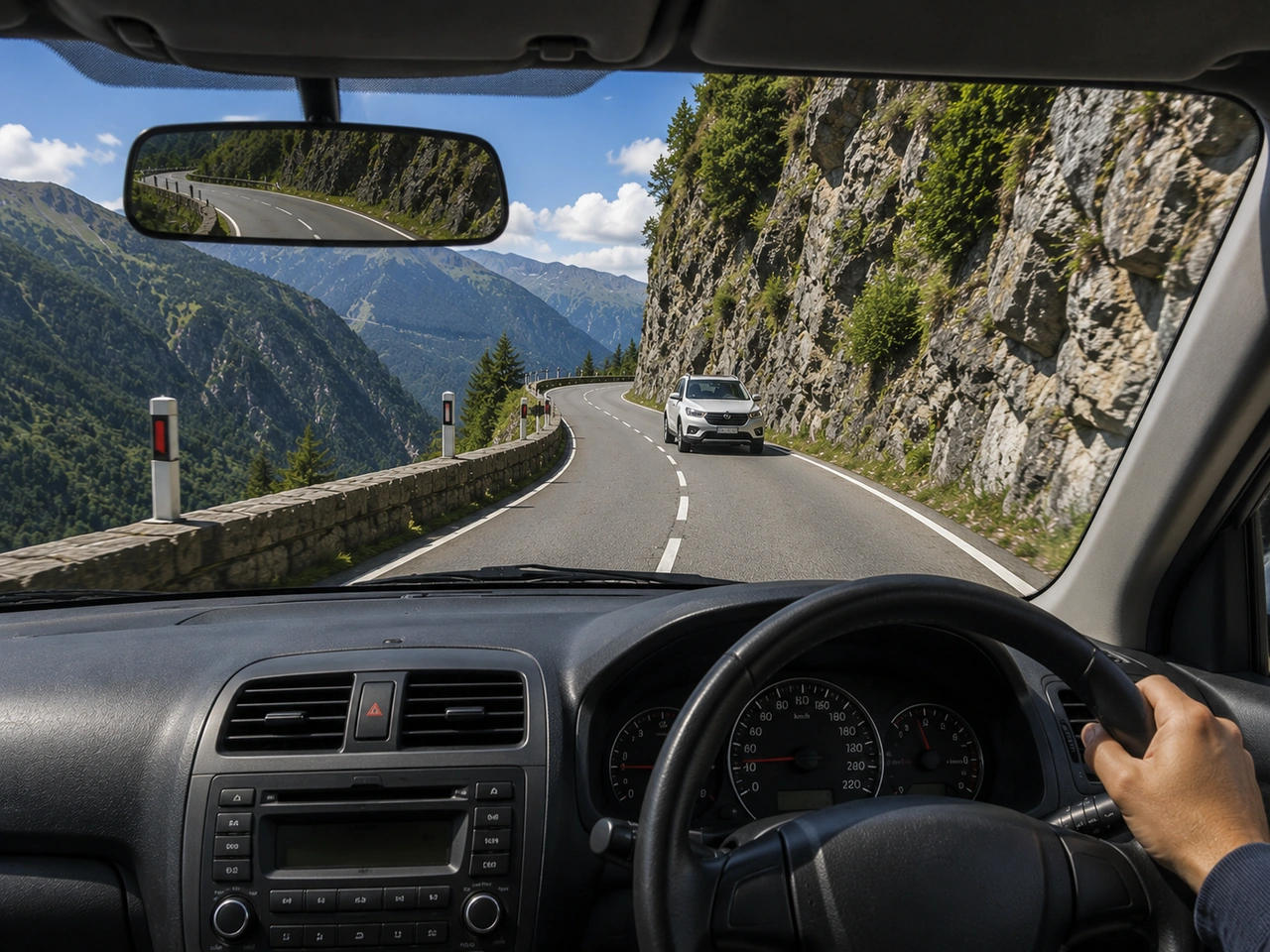 How should you approach a sharp bend on a mountain road?