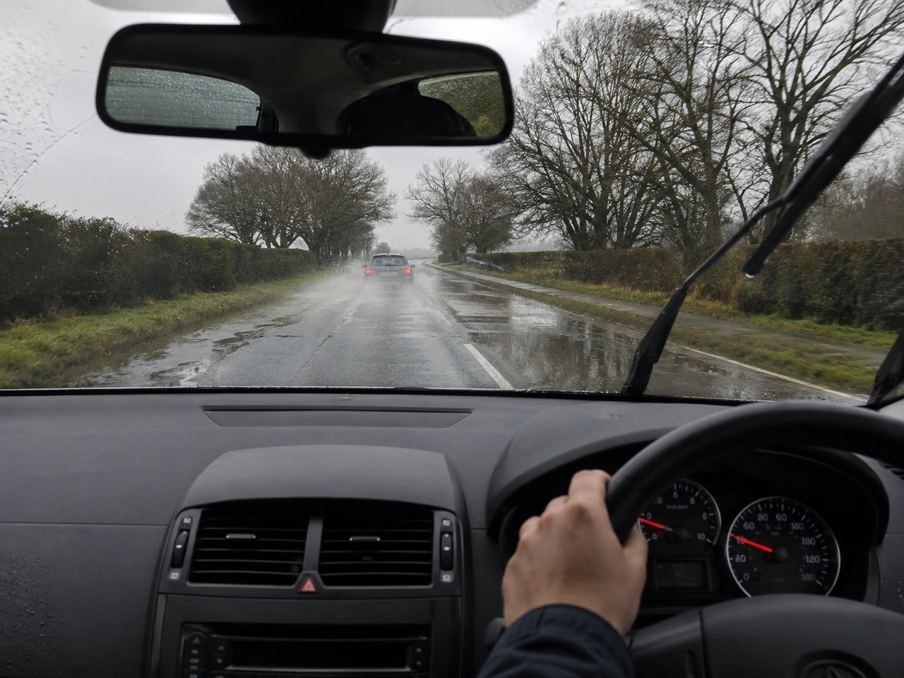 Why is it dangerous to drive through standing water at speed?