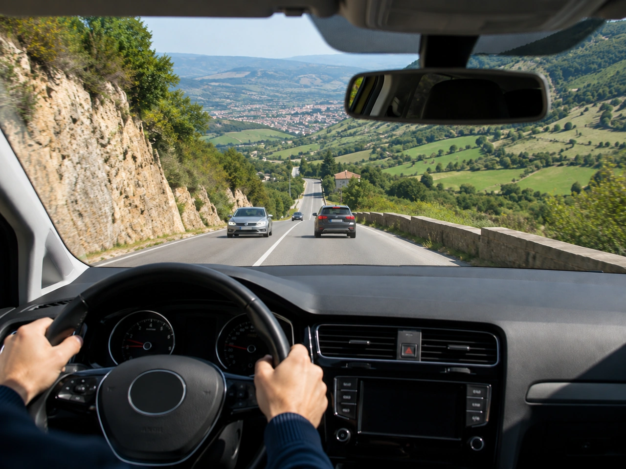 What should you do before driving down a long, steep hill?