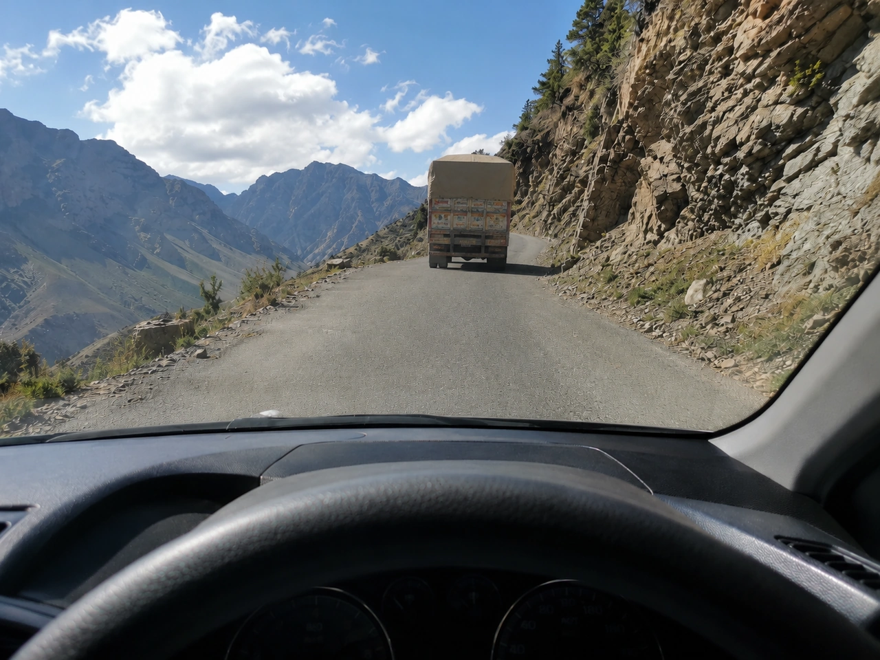 Why should you leave extra space behind a vehicle climbing a steep hill?