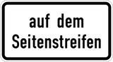 Op de vluchtstrook of berm.